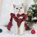 Pet wearing red Christmas tartan skirt with matching bow tie head flower