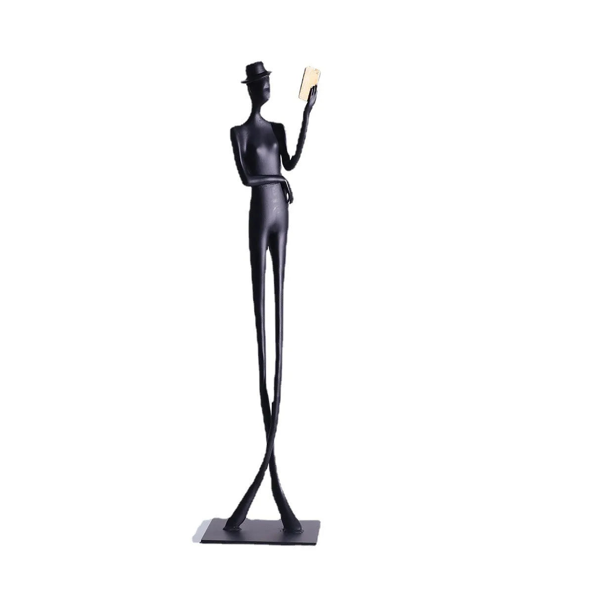 Black minimalist cast aluminum sculpture of a woman reading, 51cm tall on a desktop.