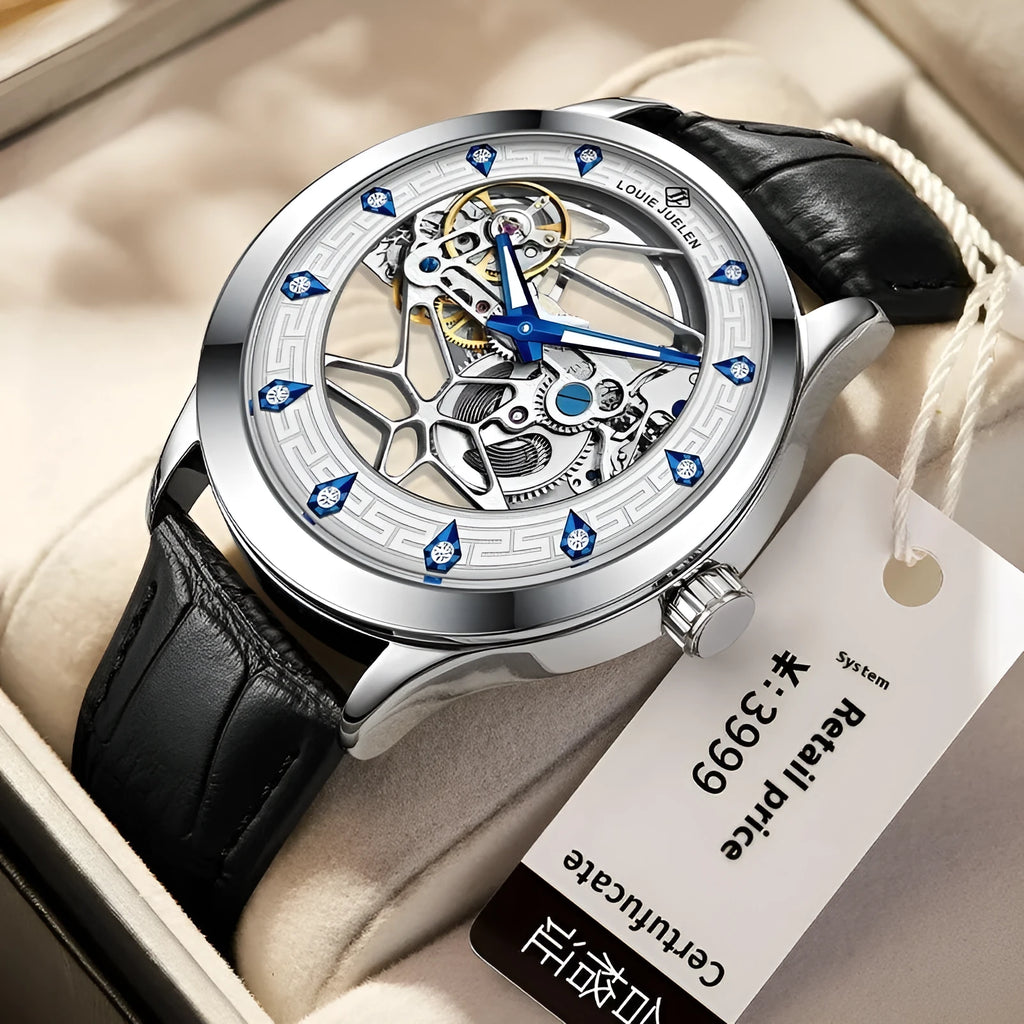 Men's silver-cased mechanical watch with white dial, blue hands, black leather strap, and butterfly buckle.