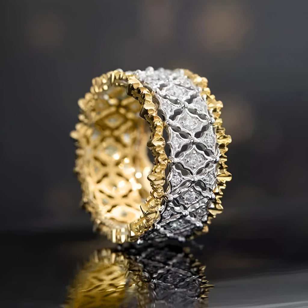 A geometric two-tone gold ring with a round zircon detail on a copper band.