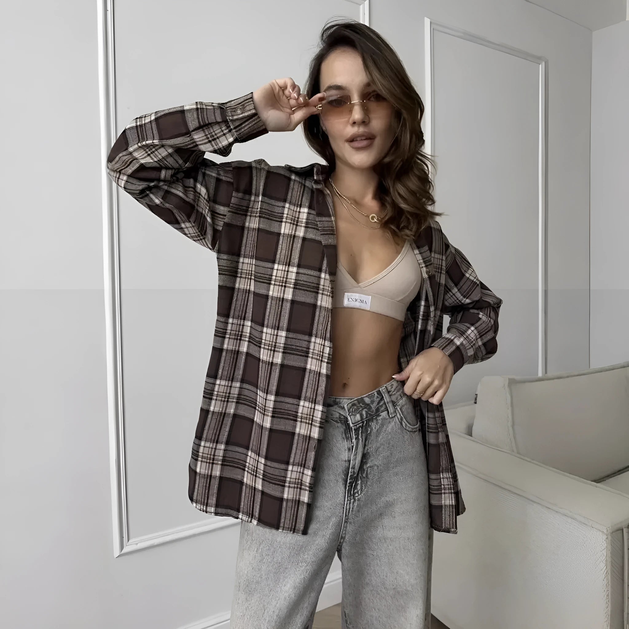 Dark brown retro striped long sleeve women's shirt on a hanger.