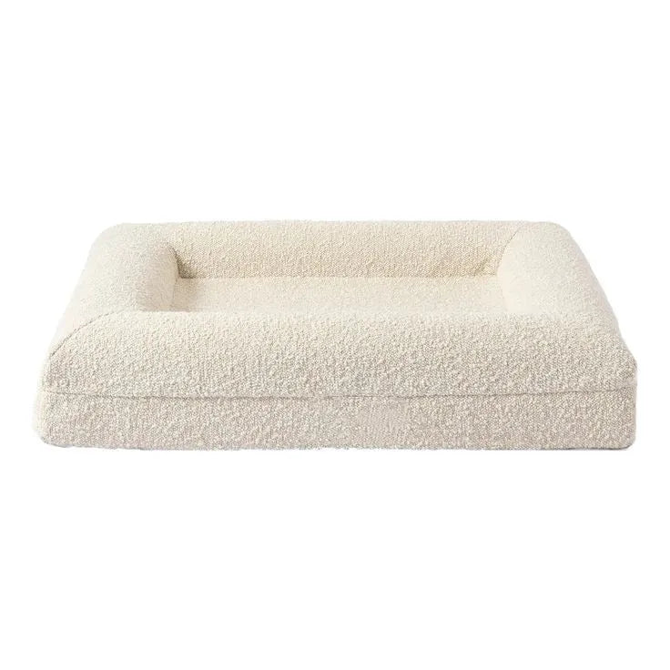 Beige rectangular cloth dog bed nest with raised edges, shown in medium size.