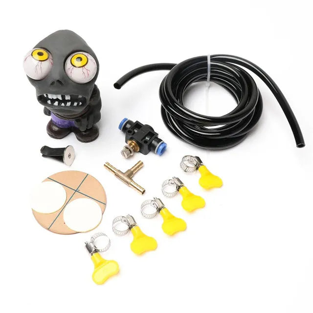 Turbo car blow-off valve pressure release kit showing rubber doll ornament, copper tube, pressure valve, and clips.