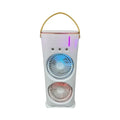 White double-ended portable USB fan with humidifying spray tank and remote control on a desk.