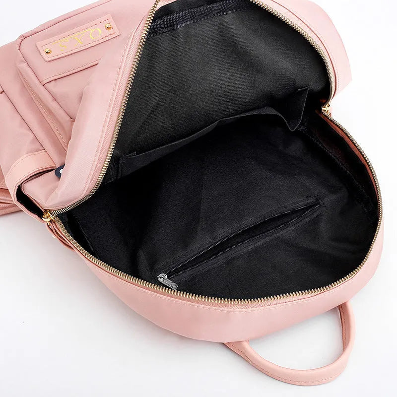 Black and pink women's casual nylon backpack showing soft surface and shoulder straps