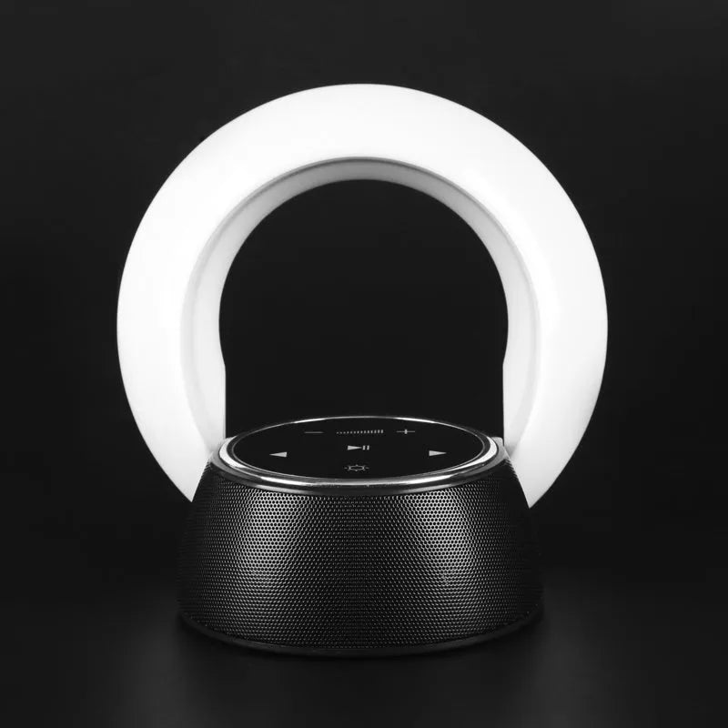 Blue and white Bluetooth speaker desk lamp with folded head on a wooden table, showing touch panel.