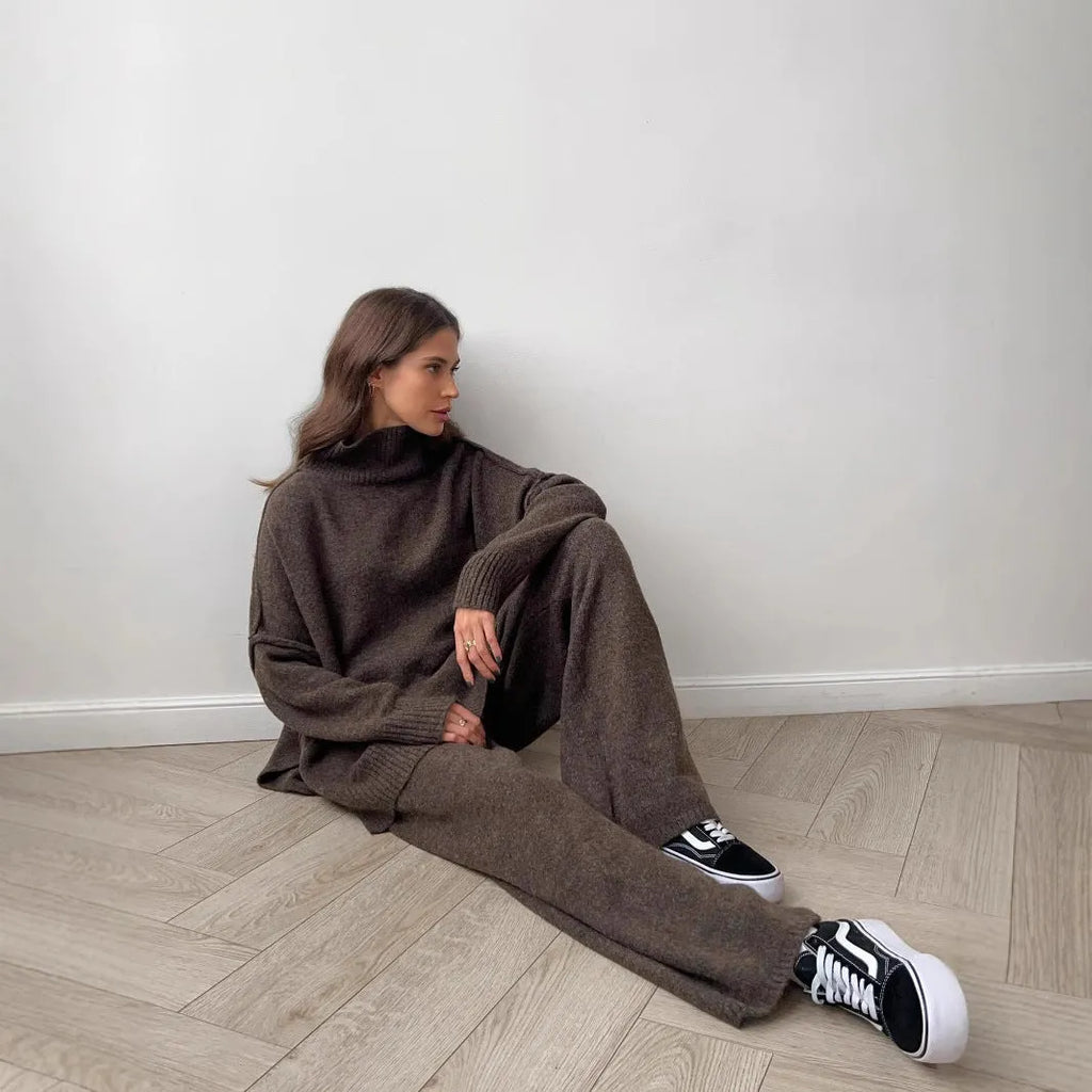 Women's grey side-slit acrylic sweater and matching trousers suit set.
