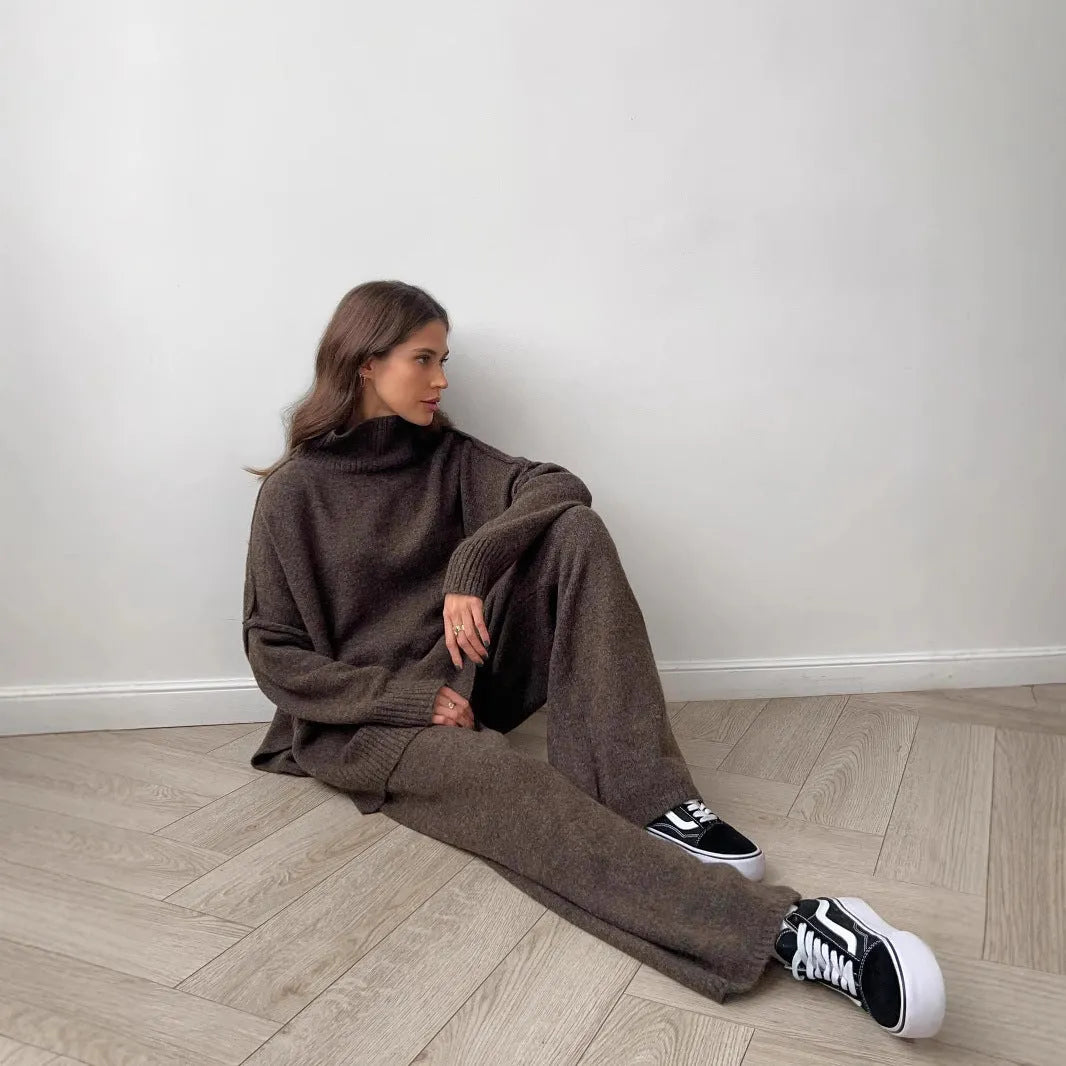Women's grey side-slit acrylic sweater and matching trousers suit set.