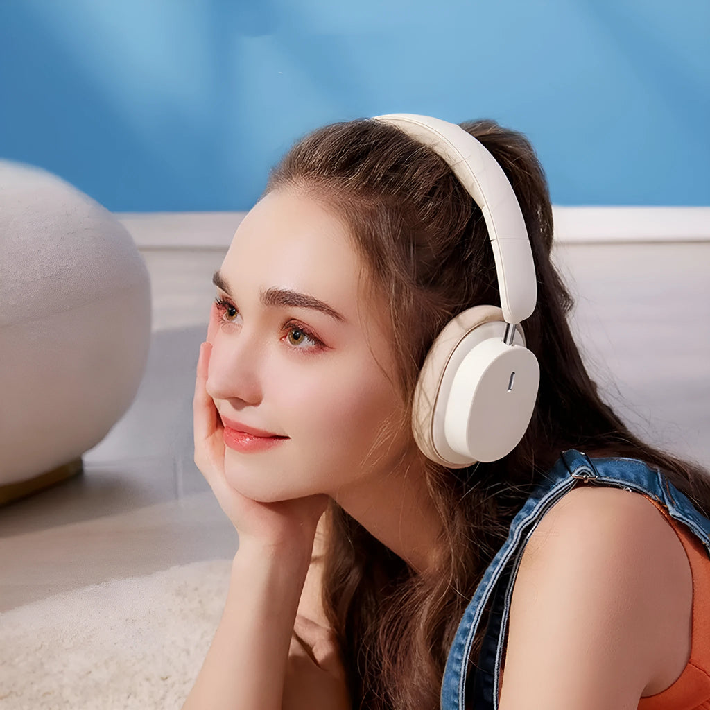 Beige and grey Bluetooth over-ear headphones with head-mounted design showing earcups and adjustable headband