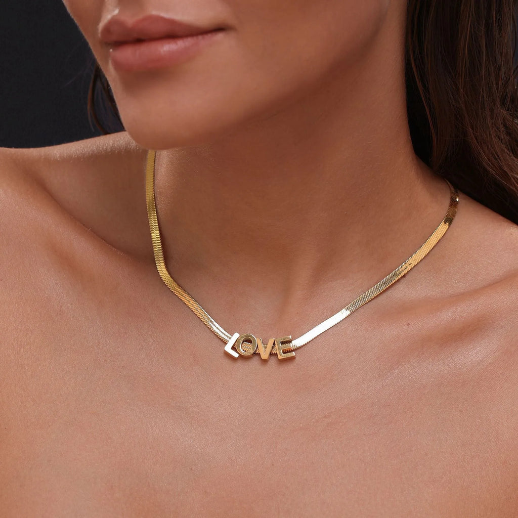 Personalised titanium steel necklace with a single letter A charm on a 40 cm gold chain.