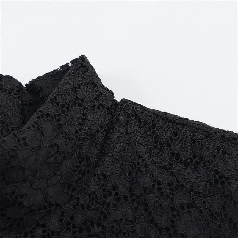 Women's black cotton short dress with lace stitching and asymmetric skirt on a plain background
