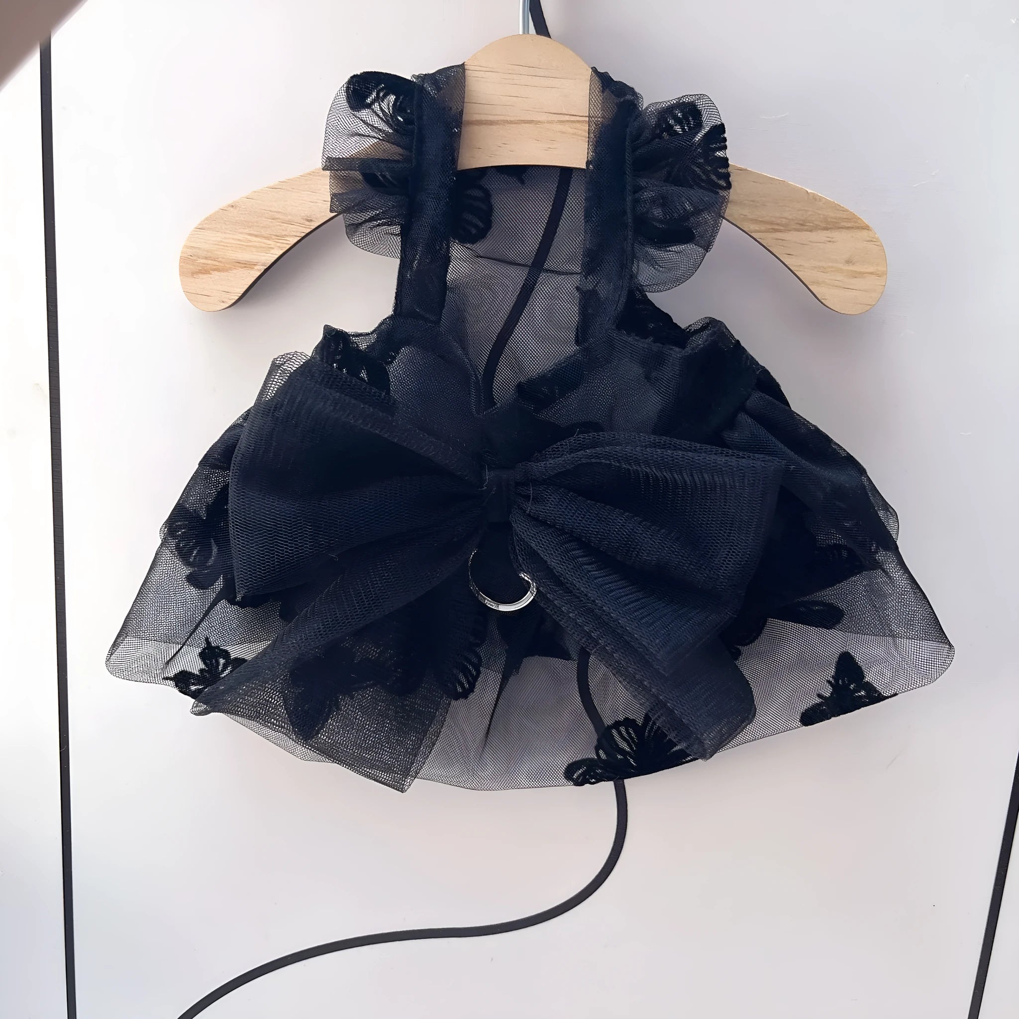 Black gauze princess skirt for a small dog on a mannequin, showing tulle material.