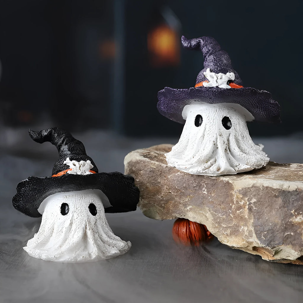 Close-up of a detailed black and a purple resin wizard hat ornament for holiday decoration.