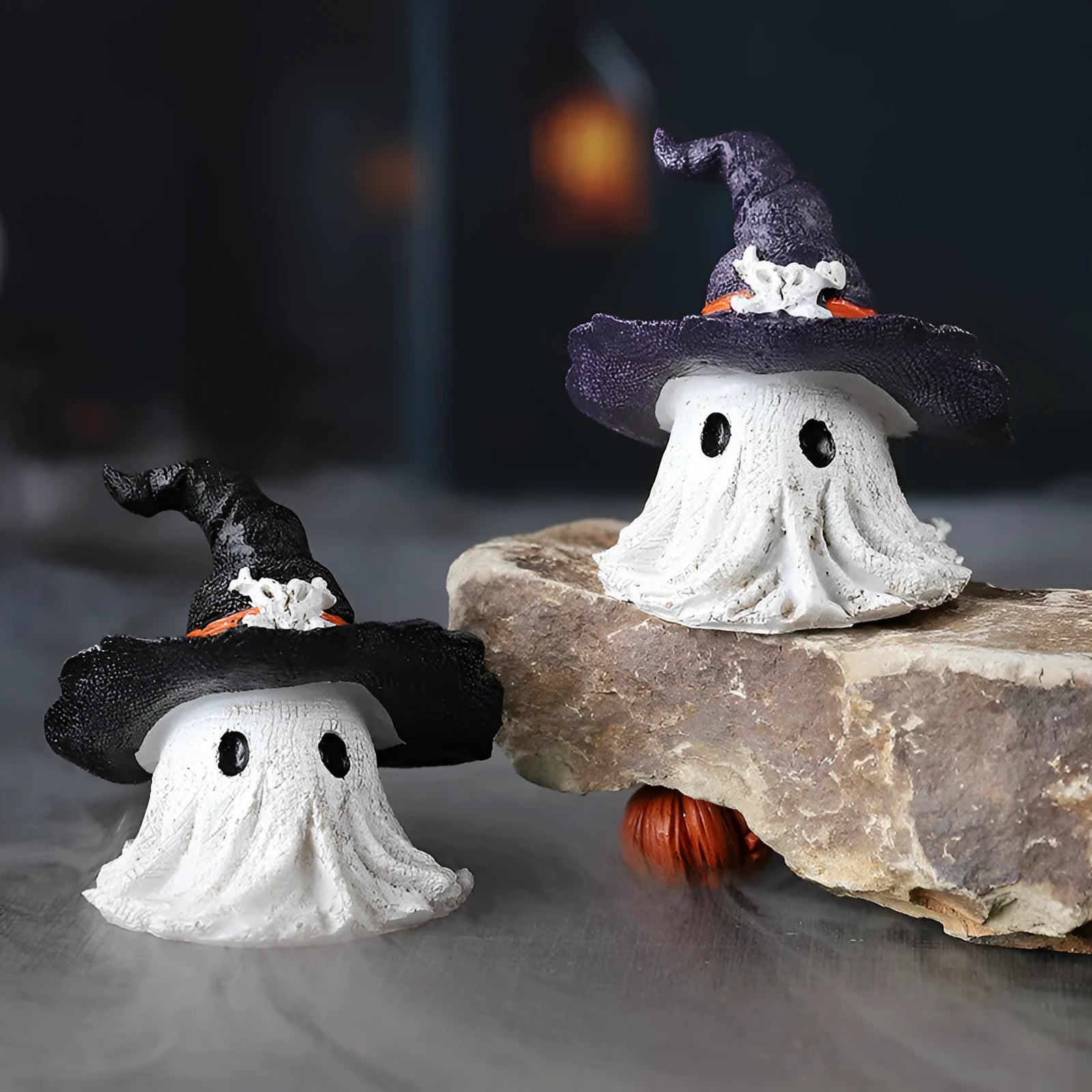 Close-up of a detailed black and a purple resin wizard hat ornament for holiday decoration.
