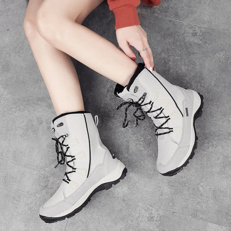 Women's black genuine leather mid-calf snow boots with round toe and thick rubber sole on a white background.