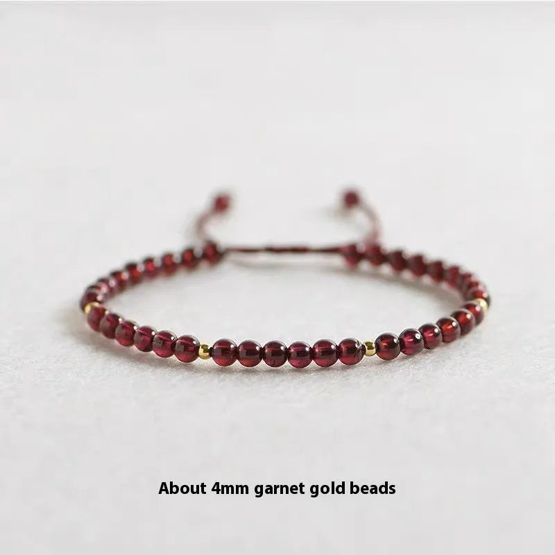 Hand-woven garnet red rope bracelet with flexible wire on a neutral background.