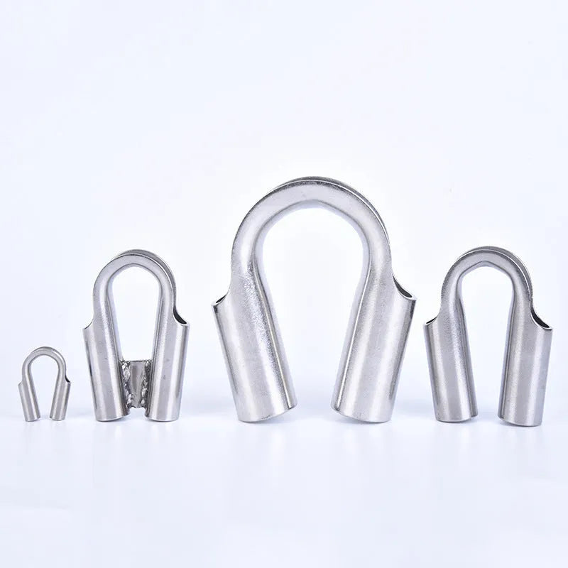 Stainless steel tubular chicken heart shaped sleeve ring set showing various metric sizes on a workbench.