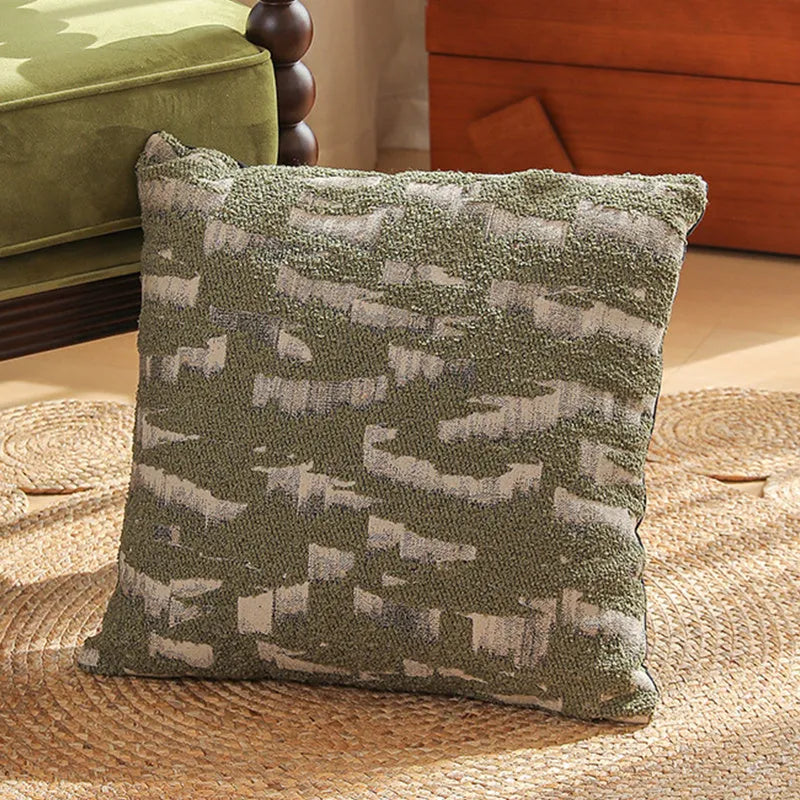 Close-up of a square Jacquard woven cushion cover with a detailed retro floral pattern in various colours.