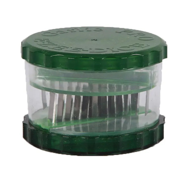 Green transparent plastic garlic peeler kitchen gadget on a countertop.