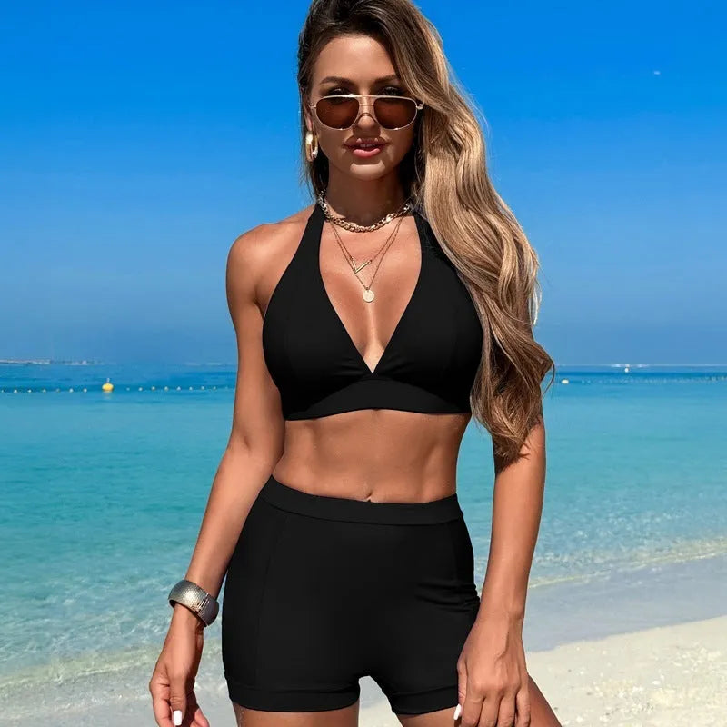Women's black bikini swimsuit laid flat, showing the two-piece sleeveless design.