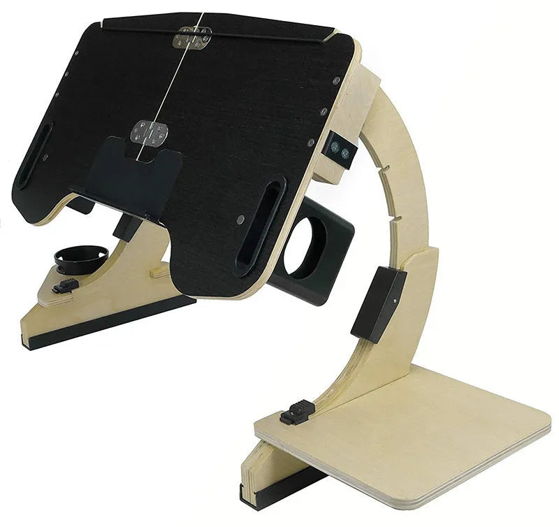 Wooden folding computer table with adjustable angle, shown in black finish on a bed.