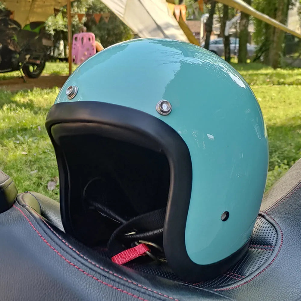 Retro-style glass fibre half motorcycle helmet shown in a selection of colours and prints.