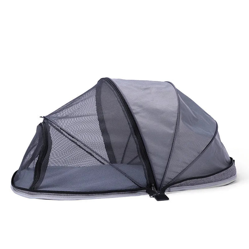 Portable folding cloth tent for cats with mesh side panels and a carry handle.