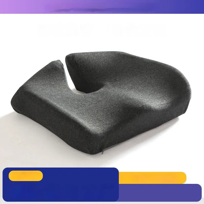 Black memory foam office chair cushion for waist support, shown on a desk chair.
