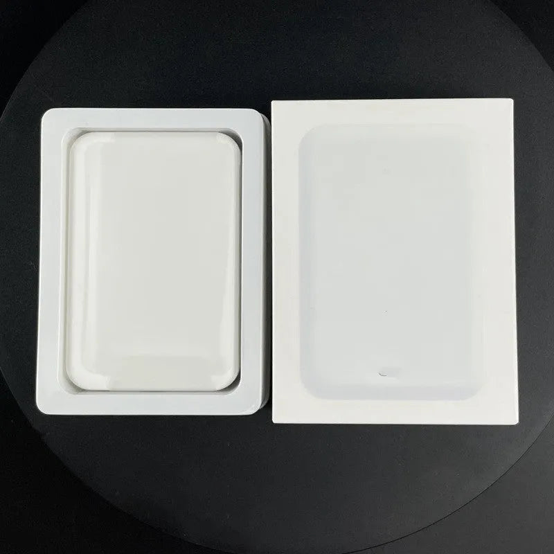 White foot-shaped portable power bank with magnetic wireless charger on a table.