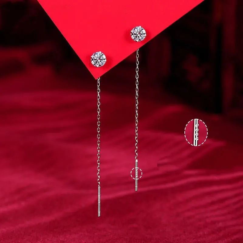 Round zirconium stud earrings with tassel rhinestone hanging in white gold colour on a geometric silver base