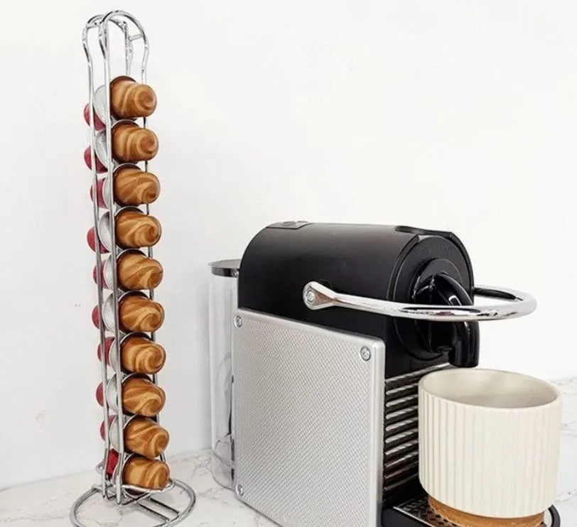 Black wrought iron coffee capsule storage rack holding pods on a kitchen counter