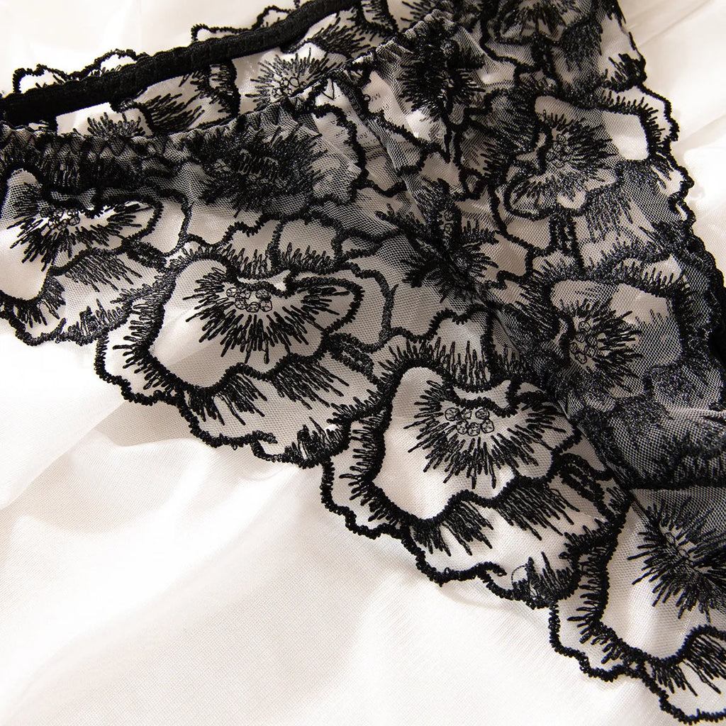 Women's black embroidered lace underwear set with steel ring details on transparent polyester fabric
