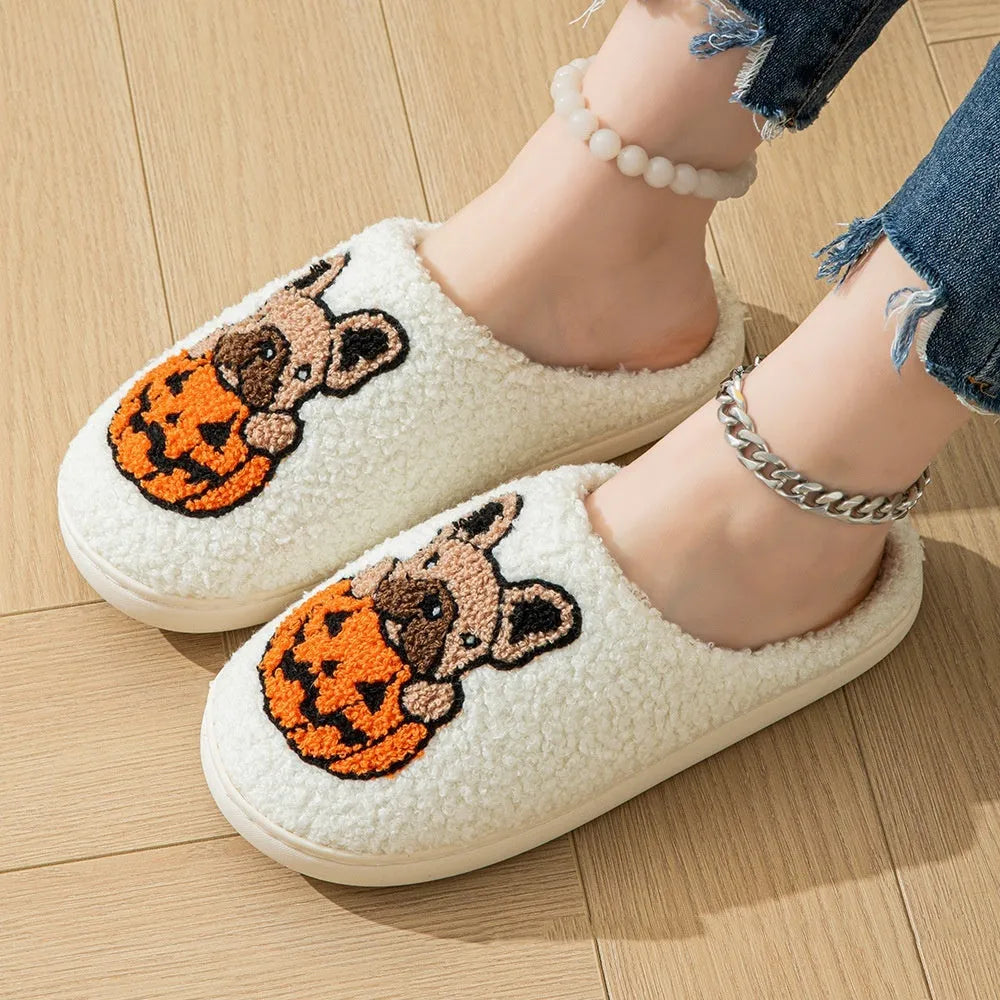 Black and white Halloween plush slippers with pumpkin pattern and non-slip rubber soles.