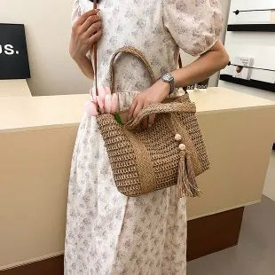 Women's straw crossbody shoulder bag with woven texture in milky white colour showing large capacity interior