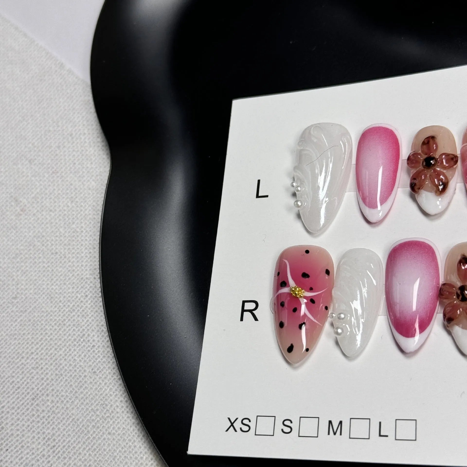 Set of hand-painted 3D carved nail beauty patches in embossed and candy patterns on a plastic sheet.