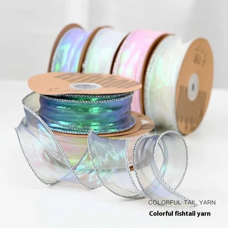 Roll of colourful fishtail yarn wave ribbon in mesh material, showing its textured, wave-like design.