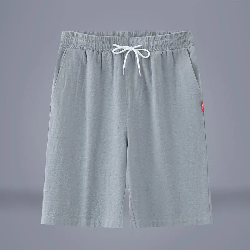 Solid colour cropped cotton linen trousers with a drawstring waist, shown in army green.