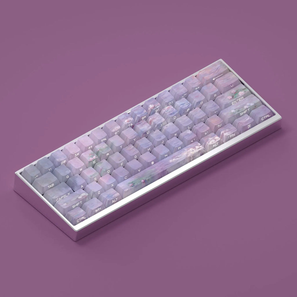 Set of white PBT keycaps with colourful water lily design on top and sides, showing side-engraved transparent characters.