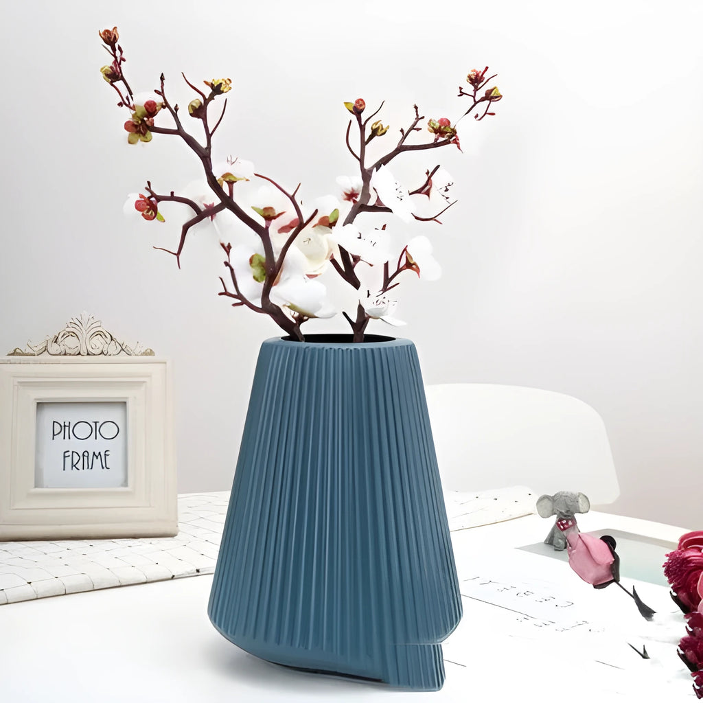 Blue melamine plastic decorative flower vase measuring 16cm by 20cm on a desktop