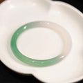 Chalcedony jade bracelet with carved southern mountain and water landscape motif.
