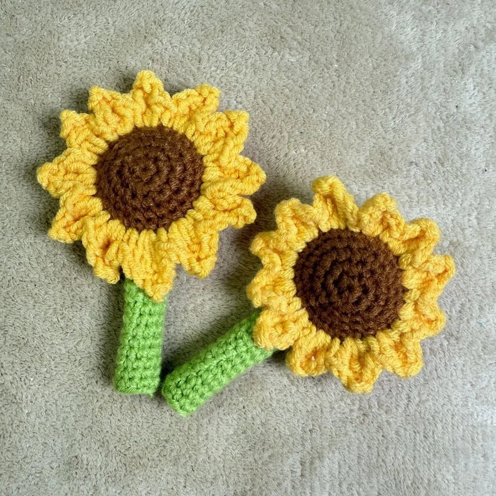 Hand-woven rattan sunflower pen cover holding a wooden pen on a desk.