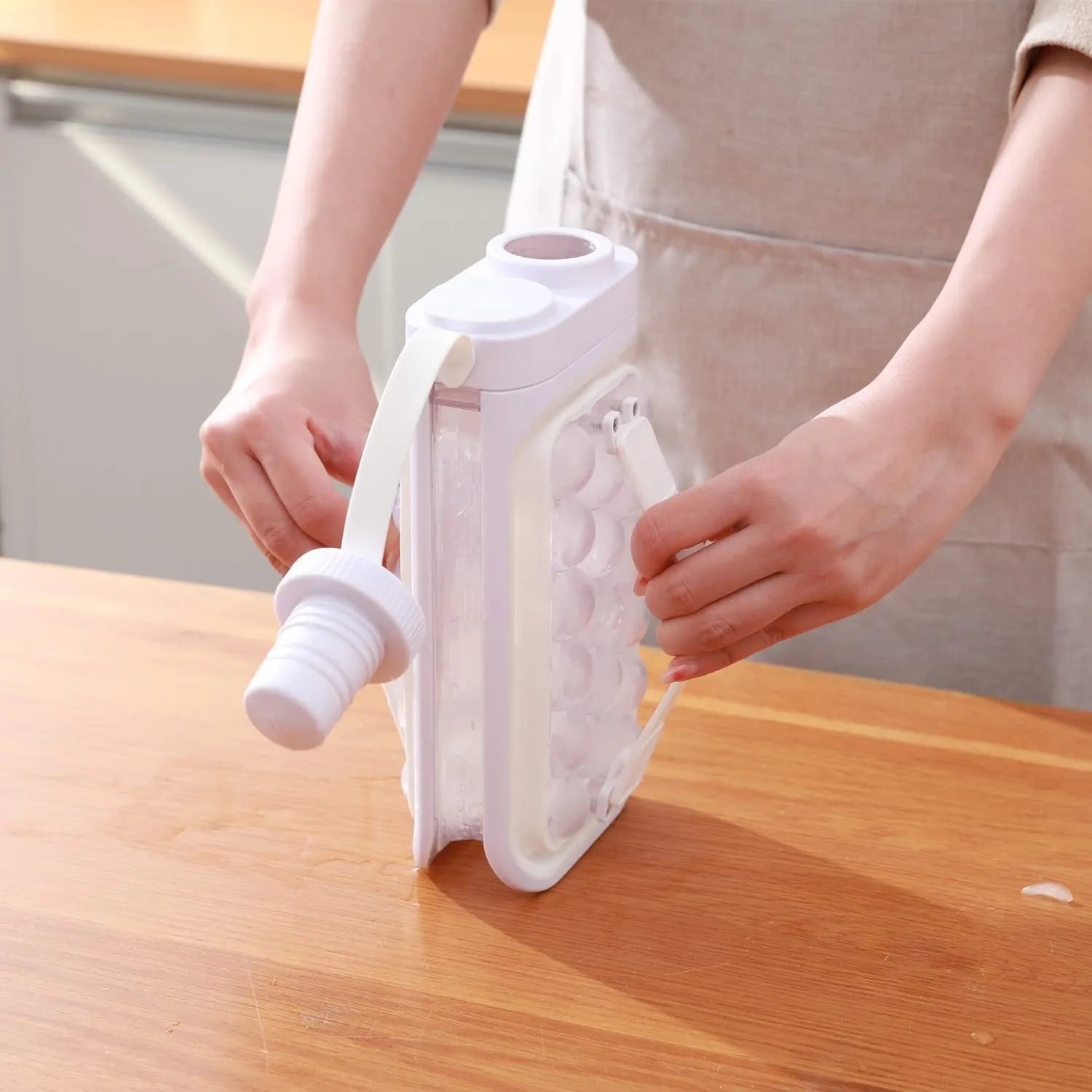 Light blue and white 2-in-1 ice ball cold kettle showing ice tray and bottle functions