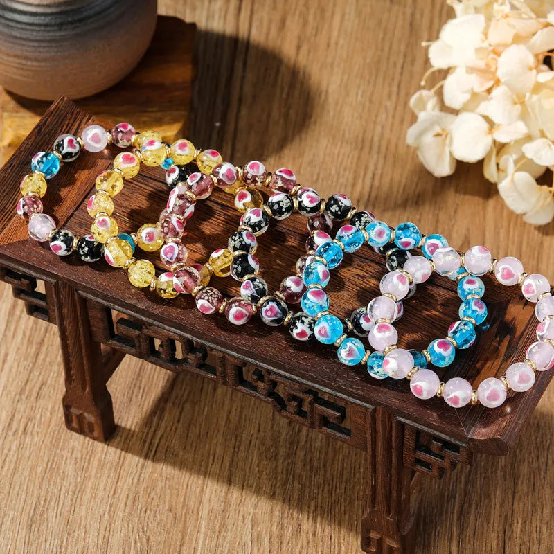 Handmade heart-shaped glass bracelet with swallowing gold beast pattern in ancient fluorescent glaze