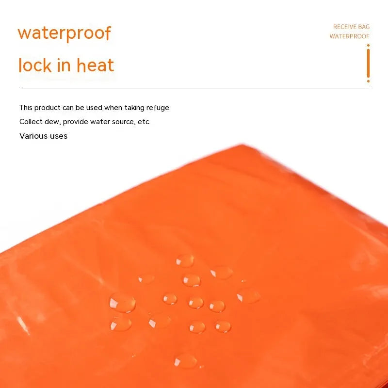Orange and green emergency tent, sleeping bag, and raincoat kit for outdoor survival.