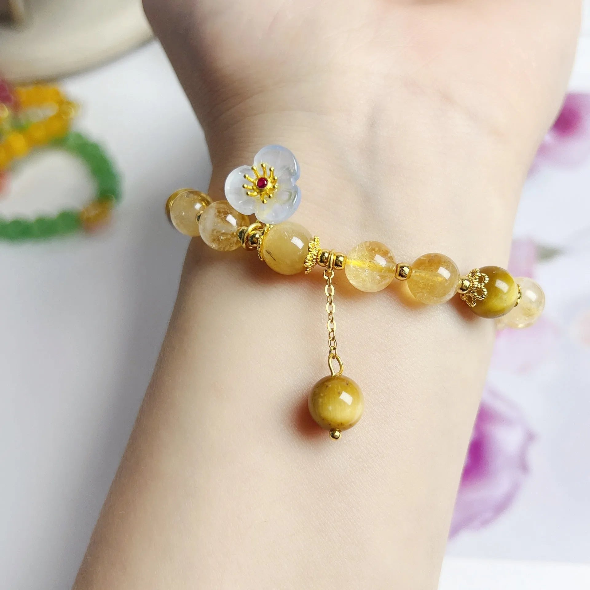 Women's citrine-coloured crystal bracelet with handcrafted flower tassel design