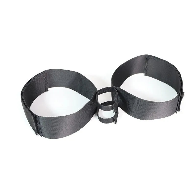 Black knitted adult toy accessory strap for harness use.