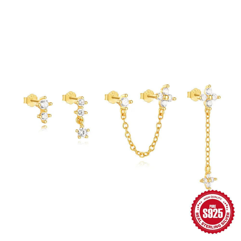 Close-up of geometric S925 sterling silver earrings with a gold electroplated clover petal design.