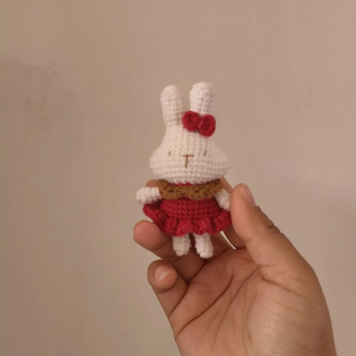 Hand-crocheted wool rabbit keychain pendant on a metal ring.
