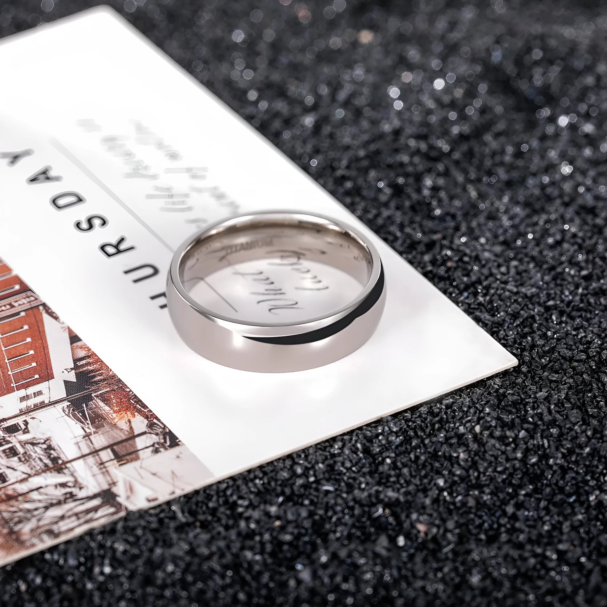 Silver coloured titanium steel unisex ring shown in 2mm, 4mm, and 6mm band width options.