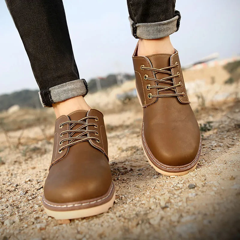 Men's black mid-top waterproof boots with flat rubber sole and PU upper
